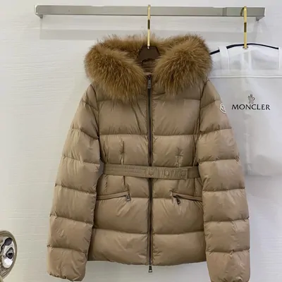 Tan hooded down coat with a fur-trimmed hood, hanging open on a rail